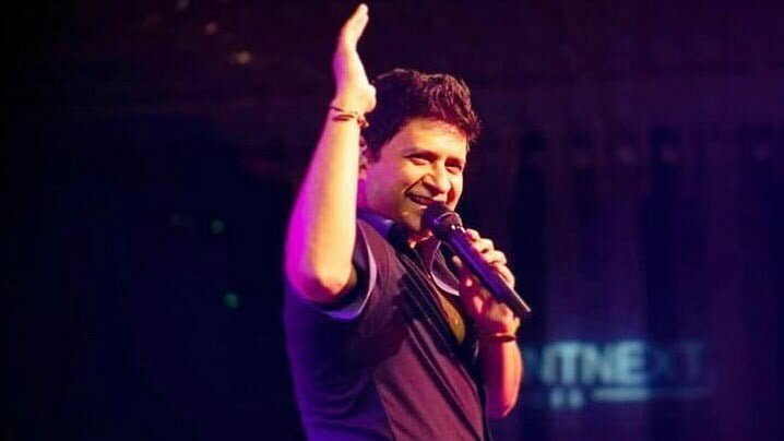 Singer KK smiling in a show