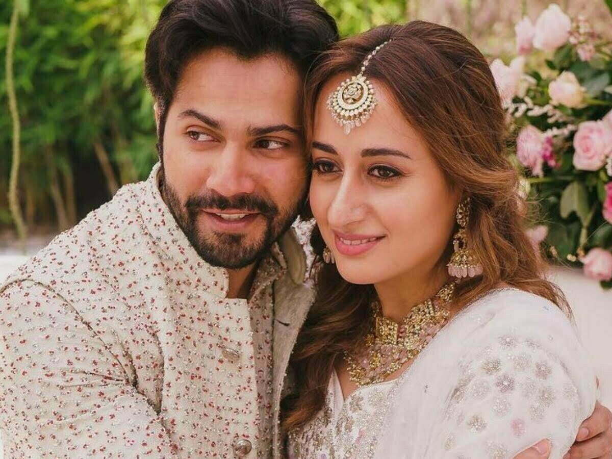Bollywood actor Varun Dhawan with his wife smiling face